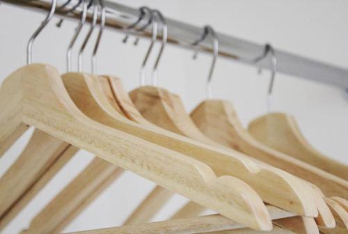 a group of wooden hangers hanging on a rack at Oxford - Private House with Garden & Parking 16 in Oxford