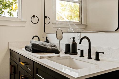a bathroom with a sink and a mirror at Boutique Home in Historic King William in San Antonio