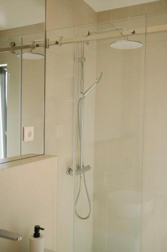a bathroom with a shower with a glass door at Aldoar House in Porto