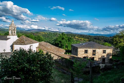 an old building with a clock tower in a village at Casa Rural Dana in Castelo