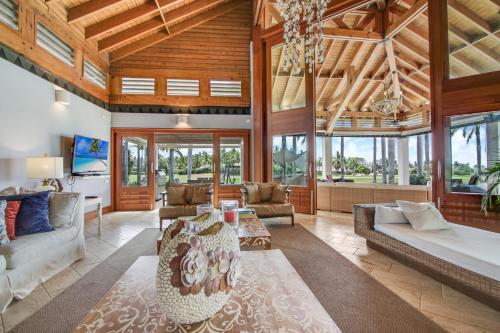 a living room with a large wooden ceiling at Luxurious 8-BR Villa with Ocean View, Jacuzzi, Home Cinema and Resort Access in Casa de Campo in La Romana