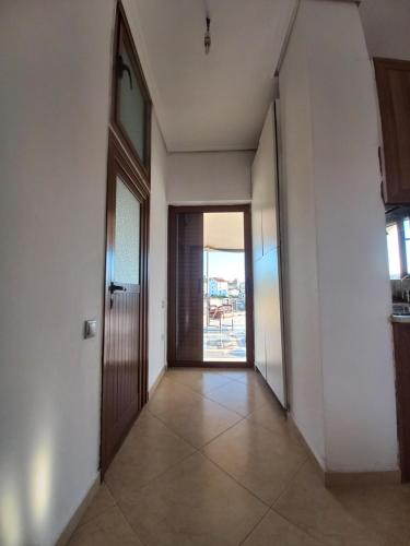 a hallway with a door leading to a patio at Arjana & Nelaj Apartments in Ksamil