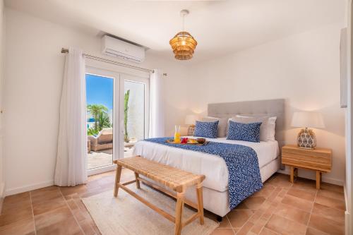 a bedroom with a bed and a view of the ocean at Beachfront Apartment Praia da Luz by Blue Diamond in Alagoas
