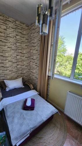 a bedroom with a bed and a large window at Apartment at Baratashvili 10 in Tbilisi City