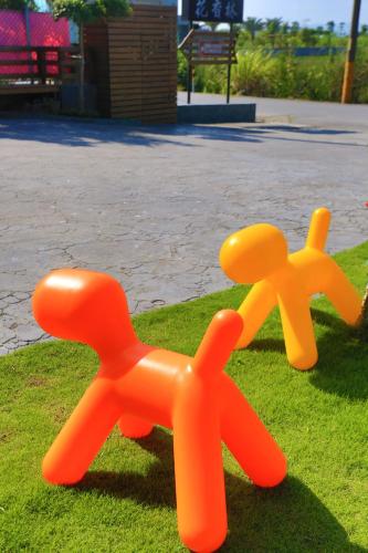 two plastic toy bears sitting on the grass at Flower B & B in Dongshan