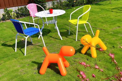 a group of chairs and a table in the grass at Flower B & B in Dongshan
