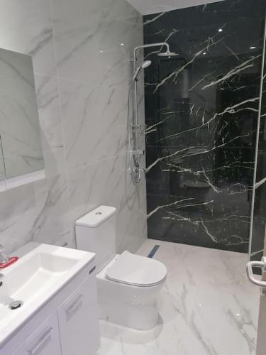 une salle de bains blanche avec toilettes et lavabo dans l'établissement MAXOR PALACE, à Protaras
