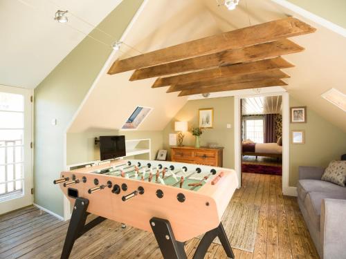 a living room with a foosball table at The Maltings - lodge with hot tub in Nethy Bridge