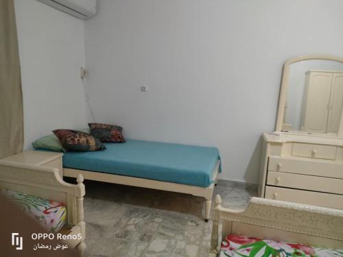 a small bedroom with a bed and a mirror at North coast in El Alamein