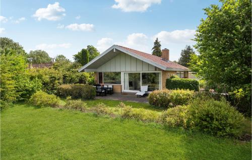 a small house with a garden in front of it at Cozy Home In Nivå With Kitchen in Nivå