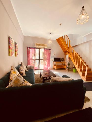 a living room with a couch and a staircase at El-sheikh Salem villa in Dahab