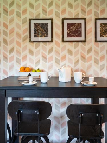 a table with two chairs in front of a wall at Eagle Lodge - Aviemore Lodges in Aviemore