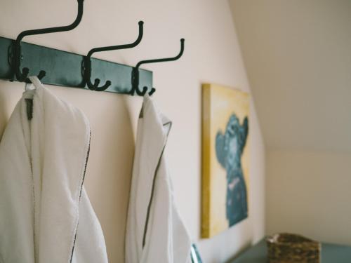 a rack of white shirts hanging on a wall at Eagle Lodge - Aviemore Lodges in Aviemore