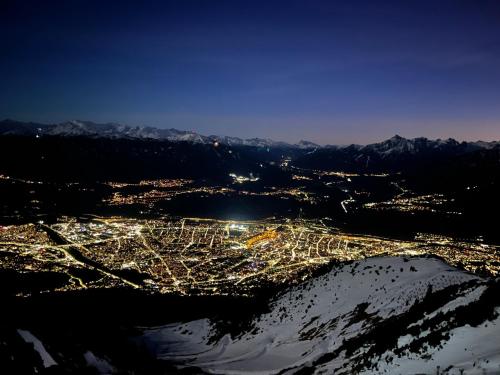 an aerial view of a city at night with mountains at Ferienwohnung Schennach in Obsteig