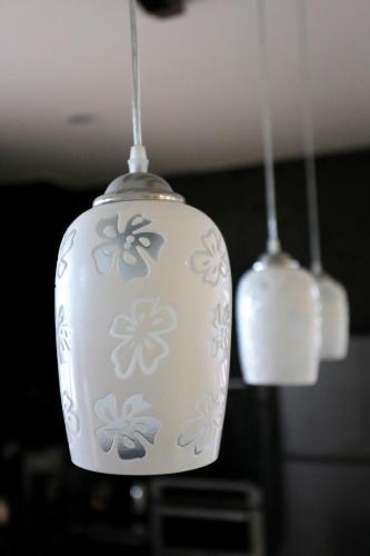 two white lights are hanging from the ceiling at Flower B & B in Dongshan