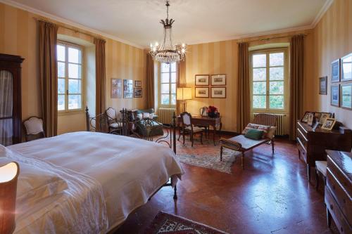 a bedroom with a large bed and a dining room at Villa della Corte - Homelike Villas in Erbusco