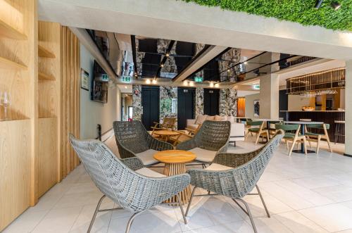 a seating area with chairs and tables in a restaurant at OMID Saldanha Hotel in Lisbon