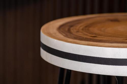 a black and white stripe on a wooden stool at OMID Saldanha Hotel in Lisbon