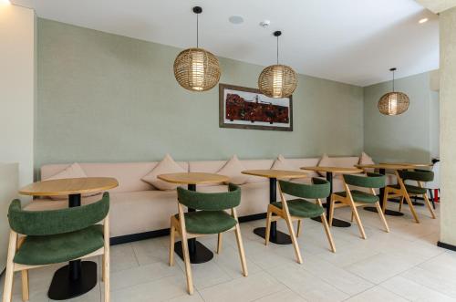 a restaurant with tables and chairs and a couch at OMID Saldanha Hotel in Lisbon
