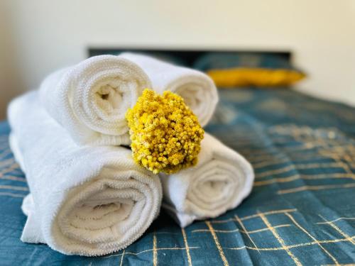 a pile of towels sitting on top of a bed at Sunshine Suites in Utrecht