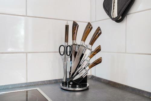 a vase filled with utensils on a counter at Haus Bergruh Fuchsbau in Todtnauberg