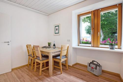 a dining room with a table and chairs and a window at Haus Bergruh Fuchsbau in Todtnauberg
