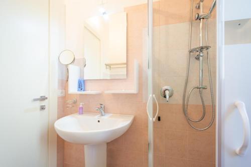 a bathroom with a sink and a shower at Casa Mian - Bed and Breakfast in Orosei