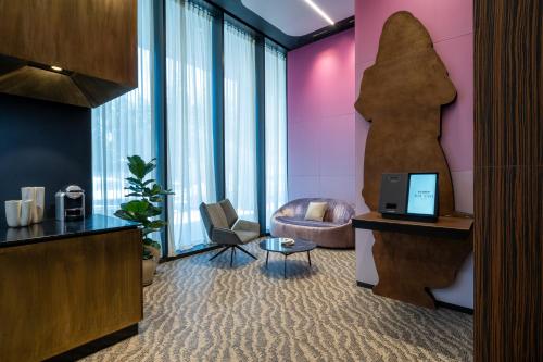 a lobby with a chair and a desk with a laptop at master Bat Yam Aparthotel in Bat Yam