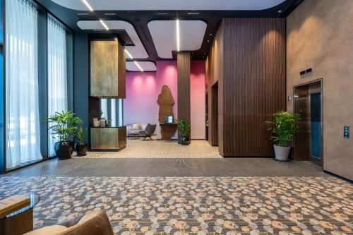 a lobby with potted plants in a building at master Bat Yam in Bat Yam