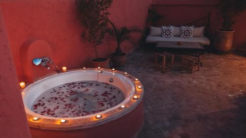 a bathroom with a tub with lights in it at Riad Dar Elma And Spa in Marrakesh