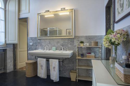a bathroom with a sink and a mirror at Villa Eden - Homelike Villas in Forte dei Marmi