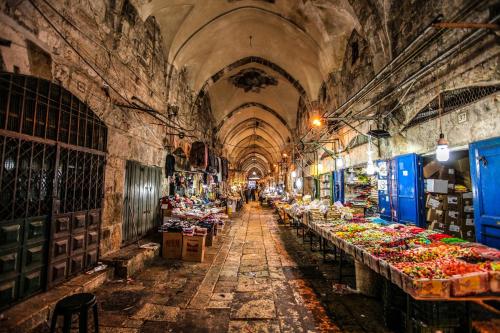a market with rows of tables in a building at Mate ALMA - By HOMY in Jerusalem