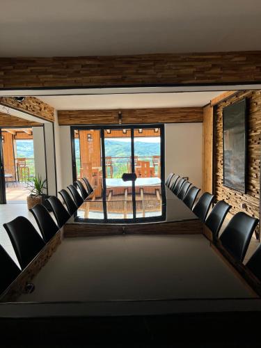 a room with chairs and a table with a view at Zdravkovac Country Club - Hotel in Topola