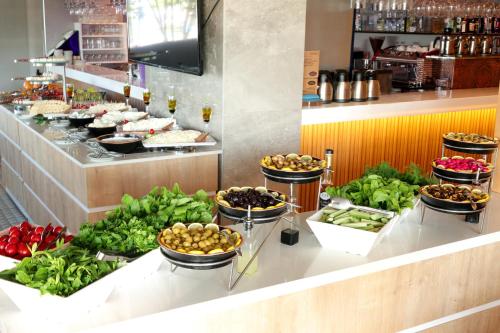 a buffet line with bowls of food and vegetables at PEARLY HOTEL in Antalya