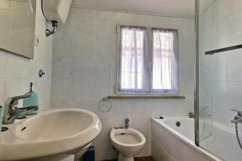 a white bathroom with a sink and a toilet at CASA DEL MARINAIO - Relax in pieno centro - WiFi - 6 posti in Porto SantʼElpidio