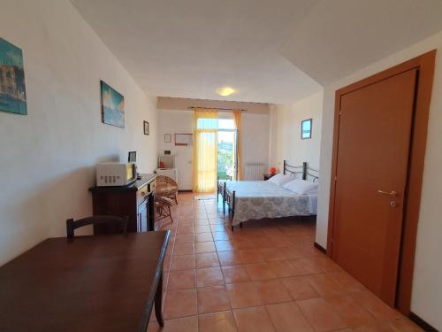 a bedroom with a bed and a desk and a table at Residence Le Meridiane in Siena