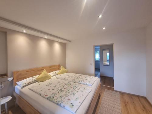 una camera da letto con un grande letto con cuscini gialli di Ferienwohnungen Rodler a Bergen