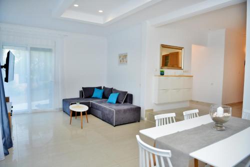 a living room with a couch and a table at J&M FALIRAKI in Faliraki