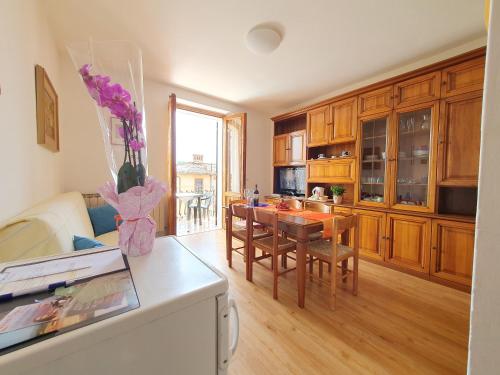 a kitchen with a table and a dining room at Residence Le Meridiane in Siena