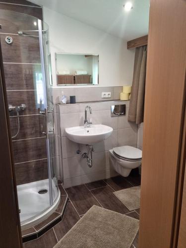a bathroom with a sink and a toilet and a shower at Haus Huber in Bach