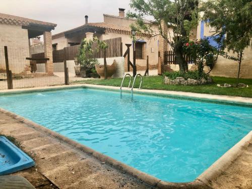 a swimming pool in front of a house at Casas rurales lagunas de Ruidera II in Ossa de Montiel