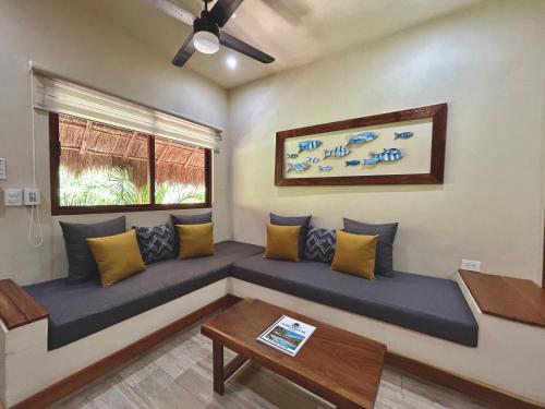 a living room with a couch and a table at Aldea Xaan Ha Tulum in Tulum