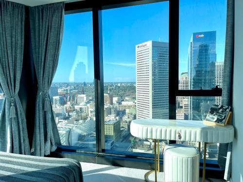a hotel room with a view of a city at Sweet Home Apartment Melbourne CBD in Melbourne