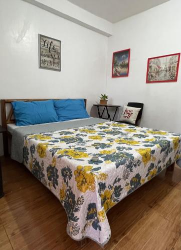 a bedroom with a bed with a floral bedspread at Treasure Beach Resort in Carles