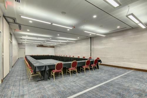 a conference room with a long table and chairs at Tulsa Marriott Southern Hills in Tulsa
