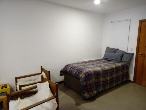 a bedroom with a bed and a bed and a chair at Hermoso Departamento Céntrico en San Martin de los Andes in San Martín de los Andes