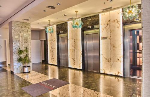 a lobby with elevators in a building at Leonardo Hotel Fuengirola Costa del Sol in Fuengirola