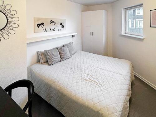 a bedroom with a bed and a window at 8 person holiday home in Bogense-By Traum in Bogense