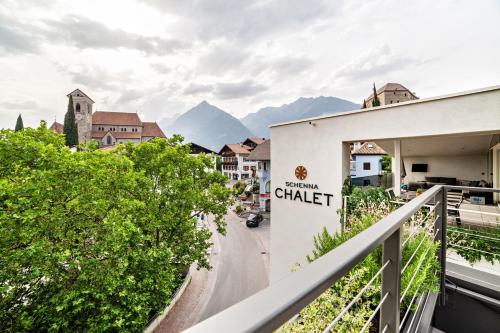 a sign for a chateau in a town with mountains at Schenna Chalet - Apt Dora in Schenna
