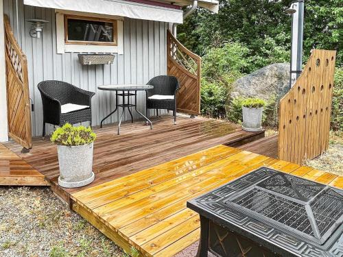 a wooden deck with a table and chairs on it at 4 person holiday home in Drottningskär-By Traum in Drottningskär